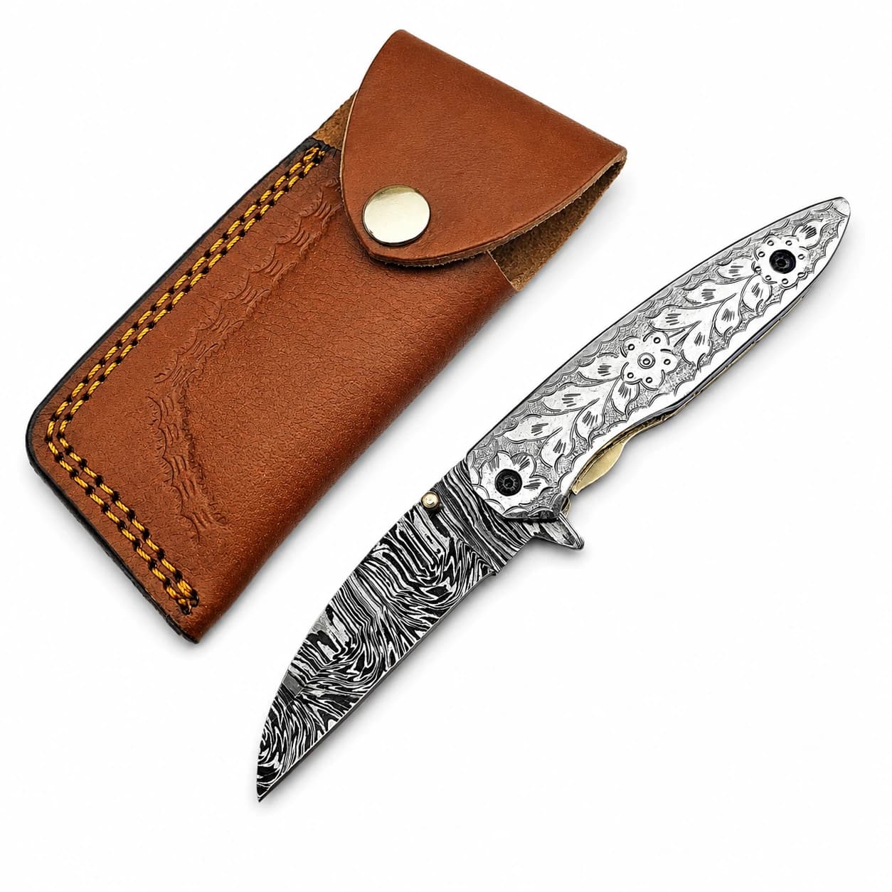 Engraved Damascus steel folding pocket knife beside its tan leather pouch